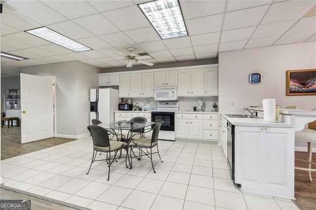 kitchen featuring white cabinets, white appliances, ceiling fan, and sink