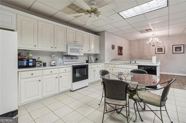 kitchen featuring white cabinets, ceiling fan with notable chandelier, light tile patterned flooring, and black appliances