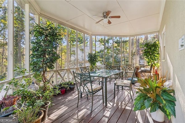 unfurnished sunroom featuring ceiling fan