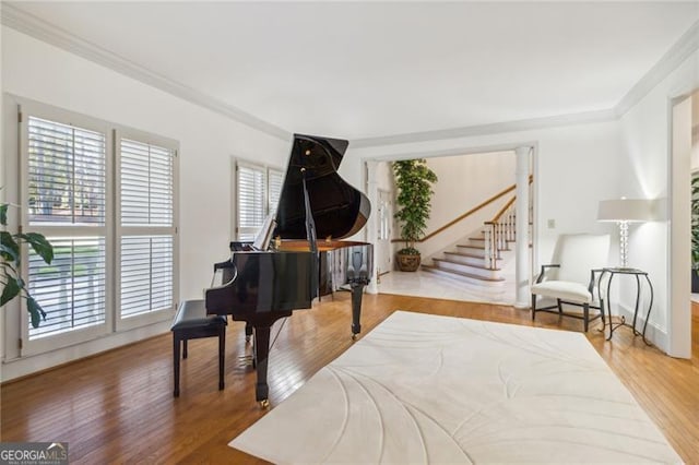 interior space with wood-type flooring and ornamental molding