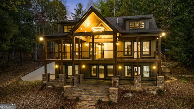 back of property featuring a patio, a balcony, and french doors