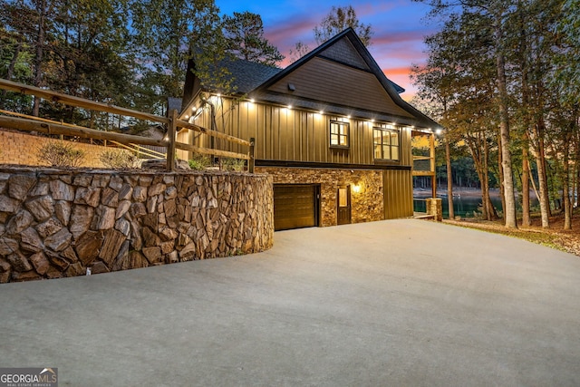 property exterior at dusk featuring a garage