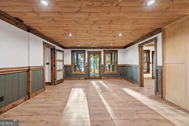 interior space with light wood-type flooring, crown molding, and wood ceiling