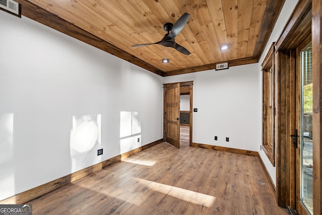 unfurnished bedroom featuring ceiling fan, wooden ceiling, wood-type flooring, and a barn door