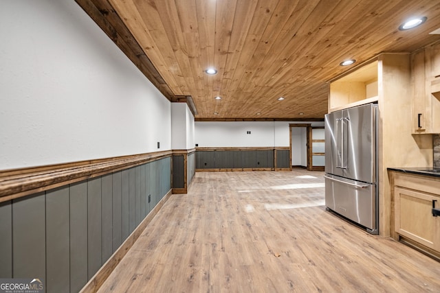 kitchen featuring light brown cabinetry, light wood-type flooring, high end fridge, and wood ceiling