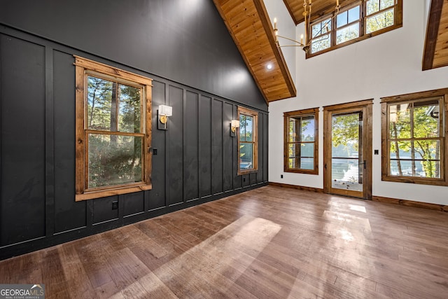 interior space featuring hardwood / wood-style floors, high vaulted ceiling, and wooden ceiling