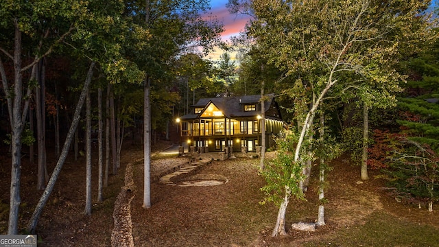 view of back house at dusk