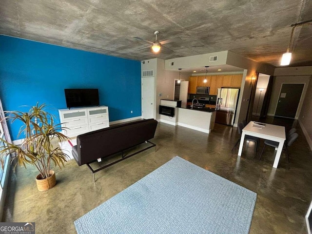 living room featuring ceiling fan and sink