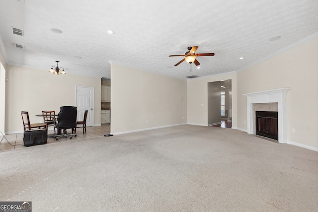 carpeted living room featuring a tiled fireplace, crown molding, a textured ceiling, and ceiling fan with notable chandelier