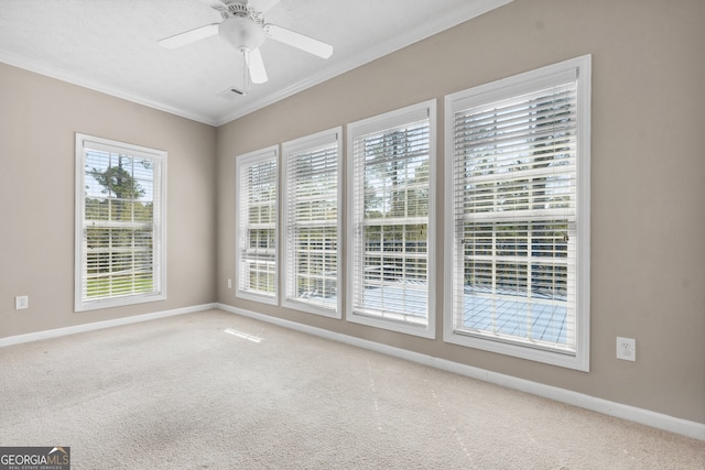 unfurnished room featuring ceiling fan, crown molding, and carpet floors