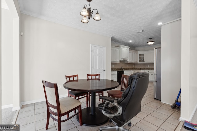 tiled dining space featuring an inviting chandelier, ornamental molding, a textured ceiling, and sink