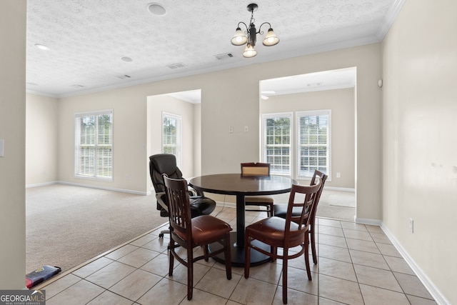 dining room with light carpet, an inviting chandelier, a textured ceiling, and ornamental molding