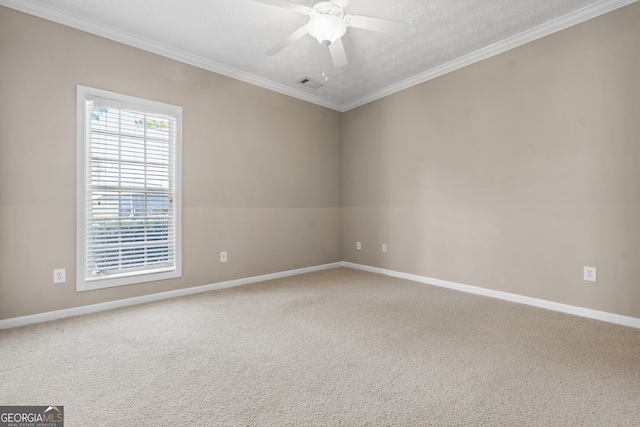 carpeted empty room with crown molding, a textured ceiling, and ceiling fan