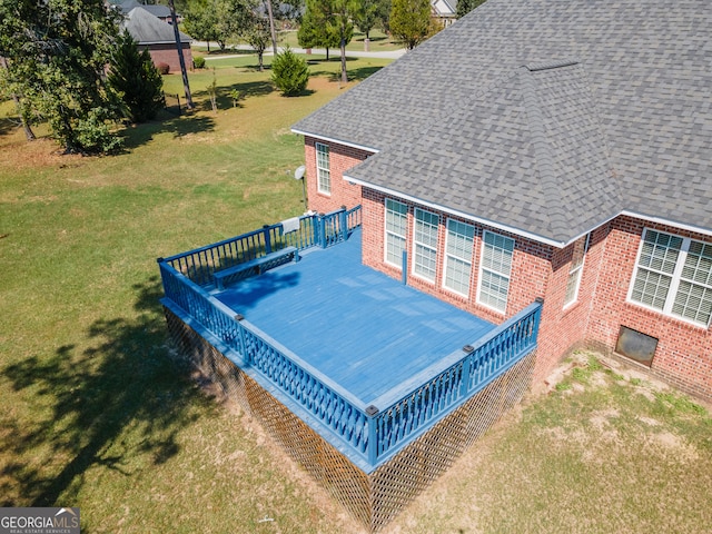 exterior space with a deck and a lawn