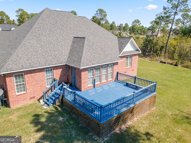 back of house with a deck and a lawn