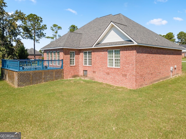 back of house with a wooden deck and a yard