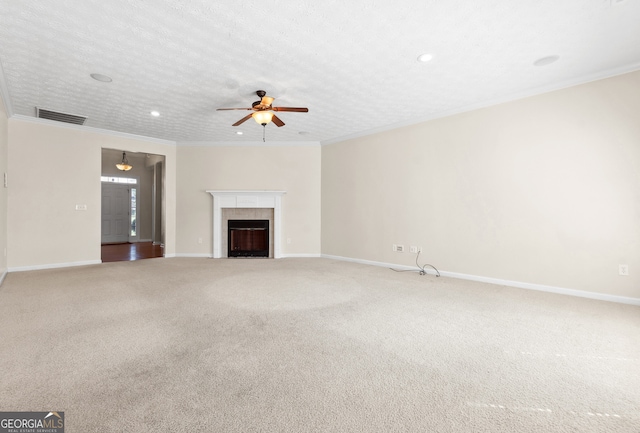 unfurnished living room with a fireplace, a textured ceiling, ornamental molding, ceiling fan, and carpet