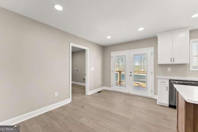 kitchen with white cabinetry, dishwasher, french doors, and light hardwood / wood-style flooring