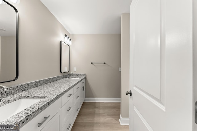 bathroom with hardwood / wood-style floors and vanity