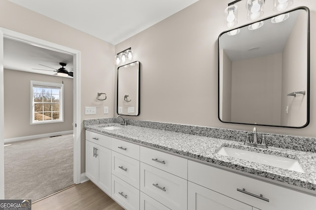 bathroom featuring hardwood / wood-style floors, vanity, and ceiling fan