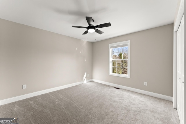 unfurnished bedroom with carpet flooring, ceiling fan, and a closet