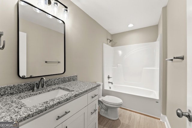 full bathroom featuring shower / tub combination, hardwood / wood-style floors, vanity, and toilet