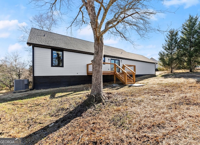 rear view of house featuring cooling unit and a deck