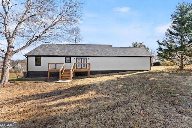 view of front of house featuring a front lawn and a deck