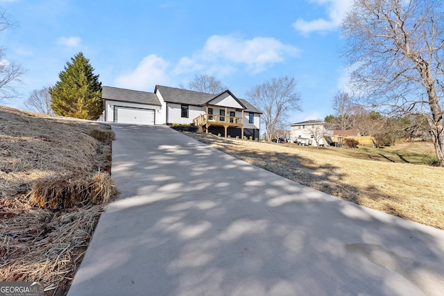 view of front of home with a garage and a wooden deck