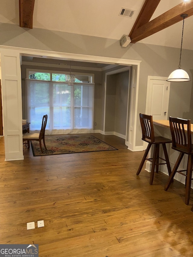 unfurnished dining area featuring high vaulted ceiling, beamed ceiling, and hardwood / wood-style floors