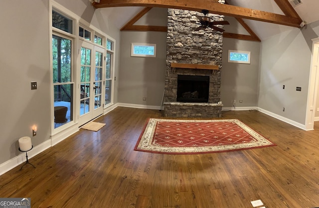 unfurnished living room featuring french doors, a healthy amount of sunlight, and dark wood-type flooring