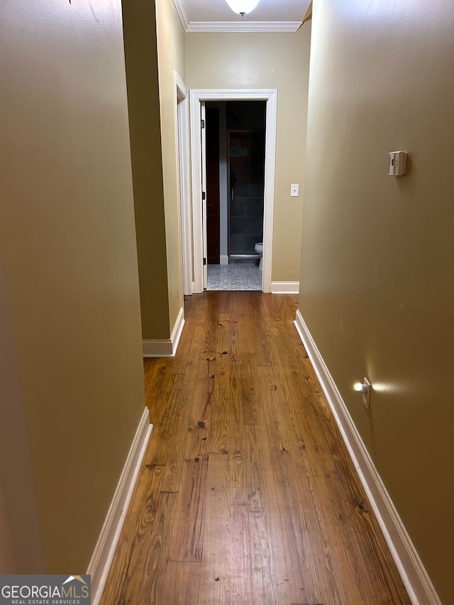 hallway featuring crown molding and hardwood / wood-style floors