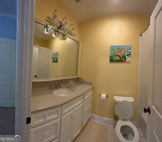 bathroom with vanity, toilet, and tile patterned flooring