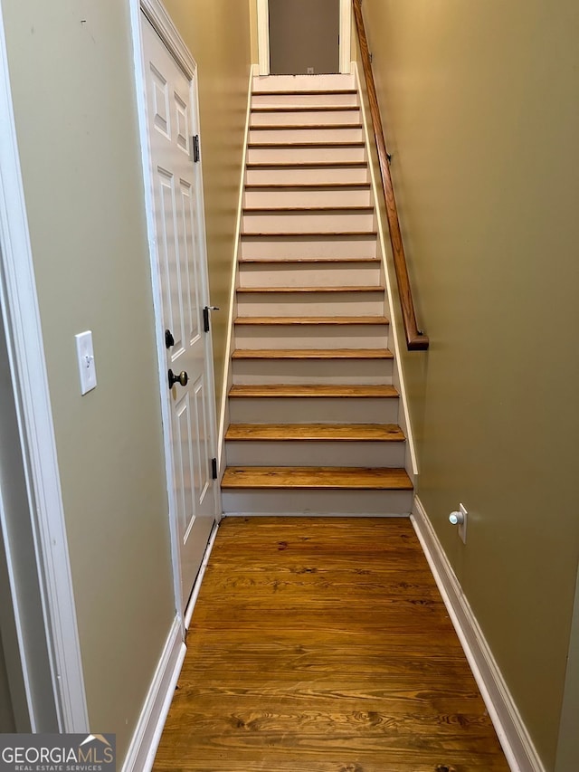 stairway featuring hardwood / wood-style flooring