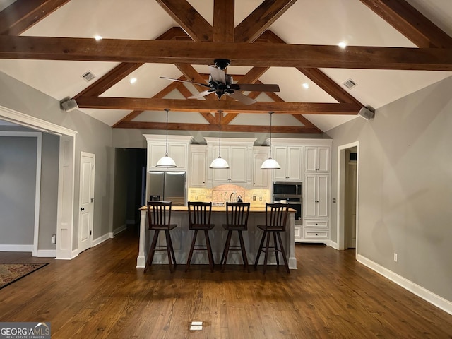 kitchen featuring a large island, hanging light fixtures, stainless steel appliances, and dark hardwood / wood-style floors