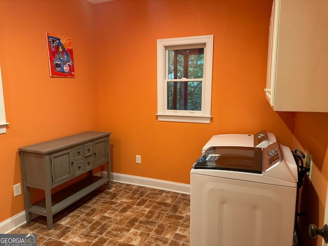 laundry area with cabinets and washer and clothes dryer