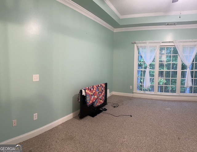 unfurnished room with crown molding, carpet floors, and ceiling fan