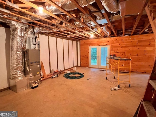 basement with french doors and wood walls