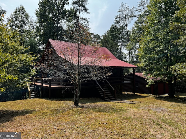 rear view of property featuring a lawn