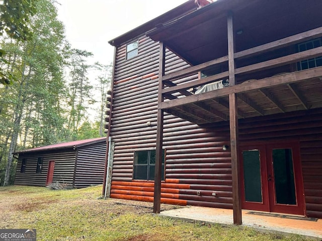 view of home's exterior featuring french doors and a wooden deck