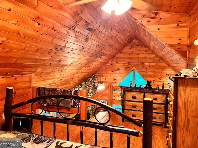 bedroom featuring wood walls, wood ceiling, hardwood / wood-style flooring, and vaulted ceiling