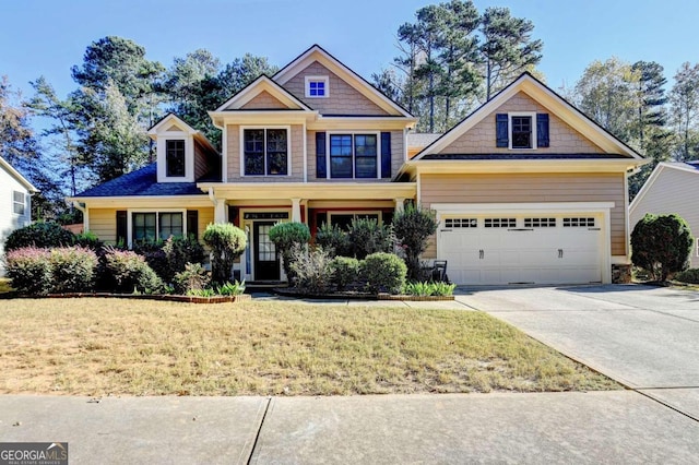 craftsman inspired home with a front yard and a garage