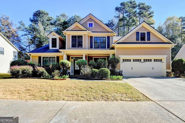 craftsman inspired home with a garage and a front lawn