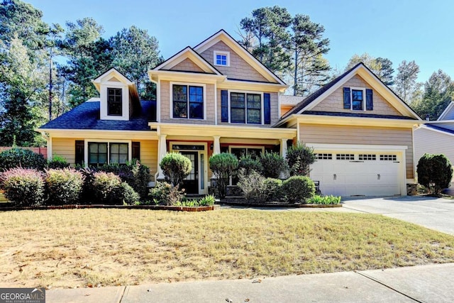 craftsman-style home featuring a front yard and a garage