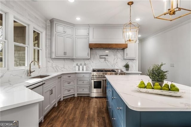 kitchen with dark hardwood / wood-style floors, hanging light fixtures, range with two ovens, sink, and light stone counters