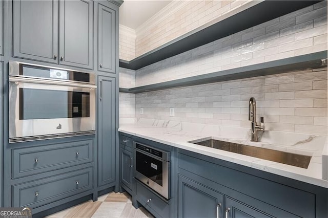 kitchen with sink, stainless steel oven, and decorative backsplash