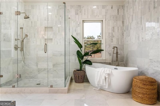 bathroom featuring tile walls and shower with separate bathtub