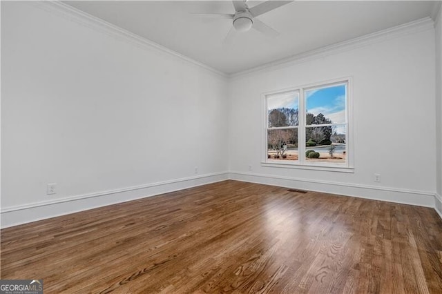 unfurnished room featuring ceiling fan, wood-type flooring, and ornamental molding