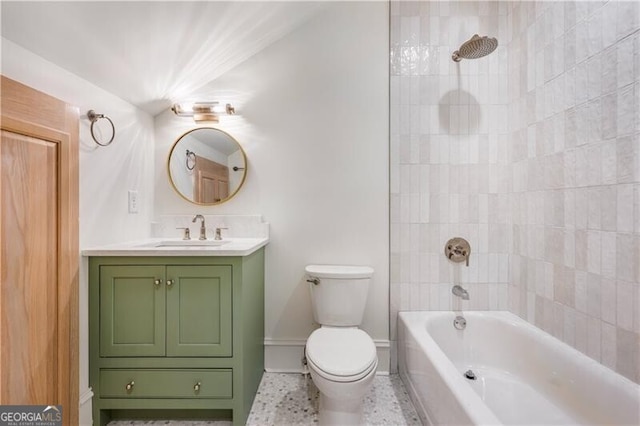 full bathroom featuring toilet, tiled shower / bath combo, vanity, and tile patterned flooring