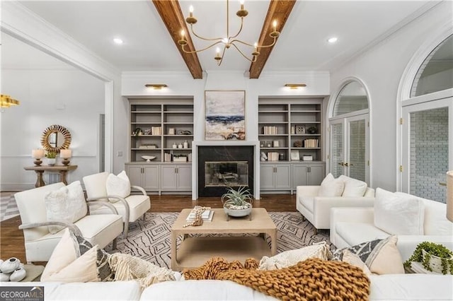 living room with beam ceiling, a fireplace, built in features, and dark hardwood / wood-style floors